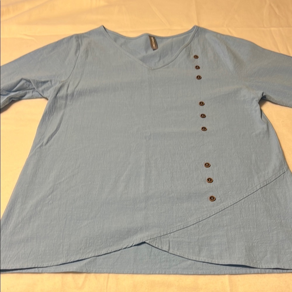 Noracora size S. Periwinkle blue shirt.
